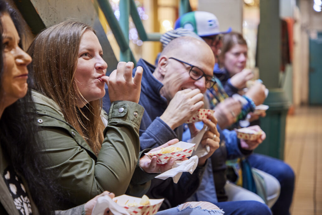 People on a Pike Place Market Food tour sample the delicious treats during the tour