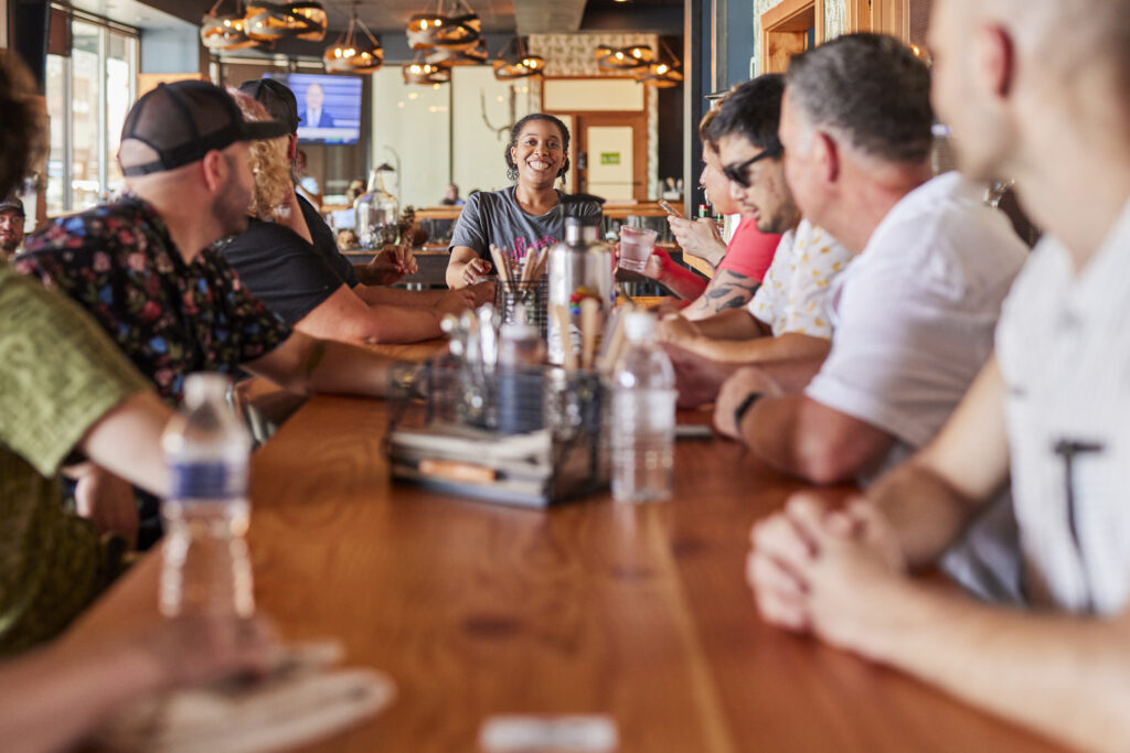 A Savor Seattle Tour guide talks to a group of tour attendees before the start of a Pike Place Market food tour