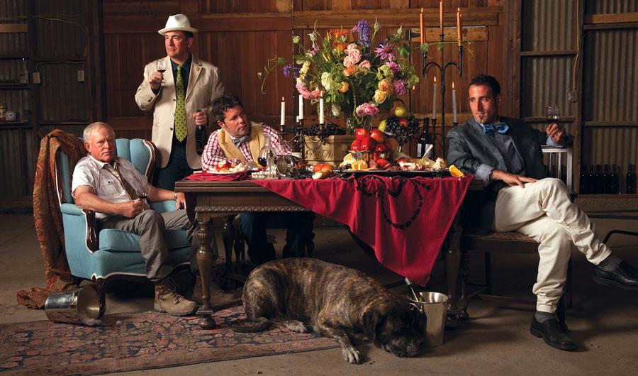 Kerloo Cellars. red table cloth, men lounging, dog sleeping, wine bottles