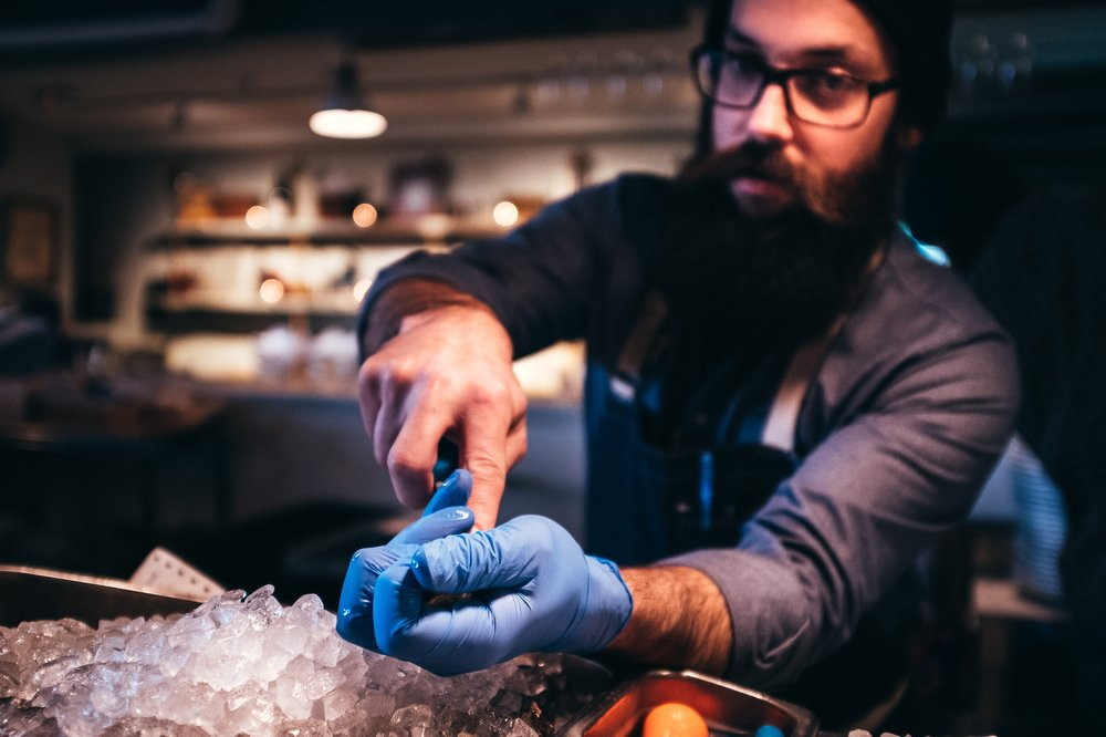 oyster shucking, ice. chef, beard, glasses